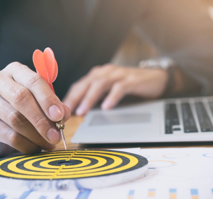 Businessman holding red dart push on target. Business strategy planning success target goals. Business development concept